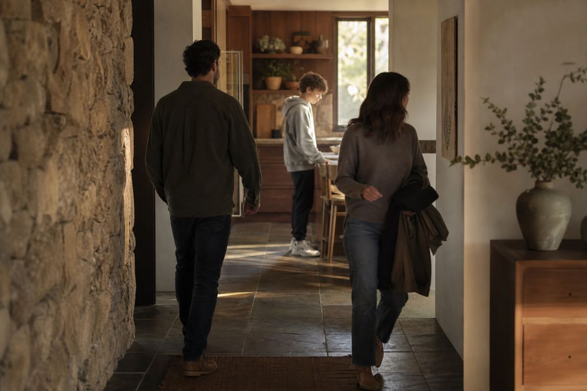 A family moving through an ordinary kitchen at the end of the day